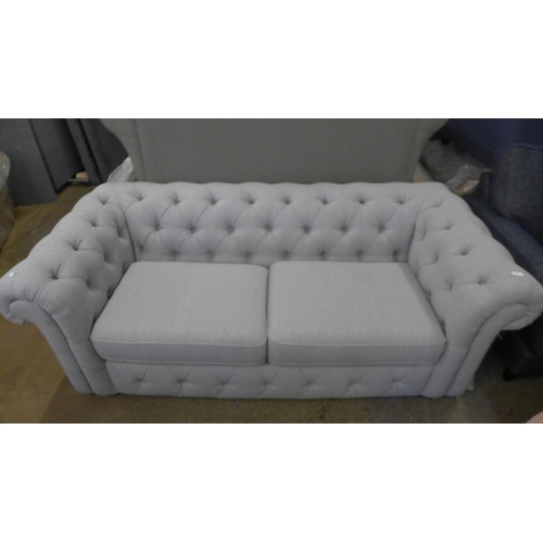 1498 - A fog grey fabric button back three seater chesterfield sofa with brown oak feet