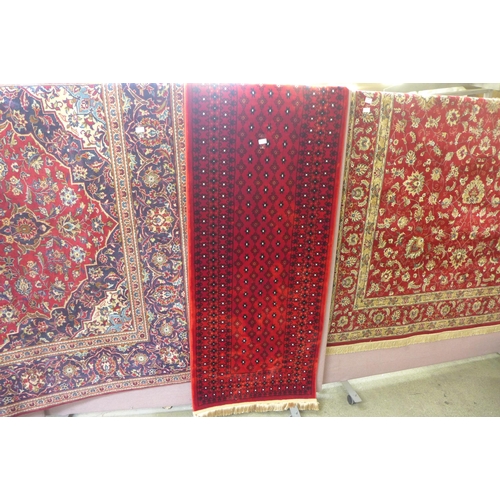 1603 - A rich red ground full pile Turkish runner with an all over design, 300 x 80cm