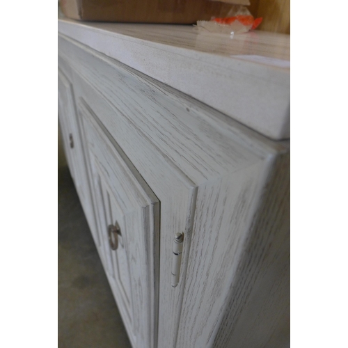 1667 - A white painted washed oak and marble top three door sideboard