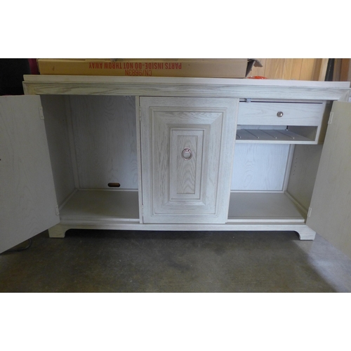 1667 - A white painted washed oak and marble top three door sideboard