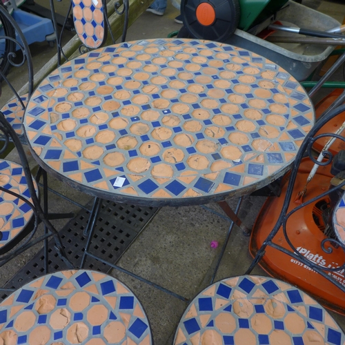 2321 - A 1 metre diameter circular mosaic topped garden table and four chairs