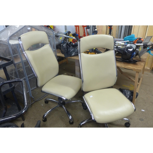 2338 - Two cream leather/chrome cantilever rise/reclining chairs