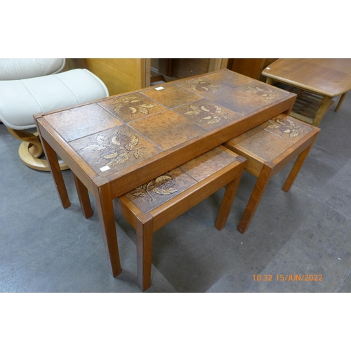 63 - A Danish teak and tiled top nest of tables