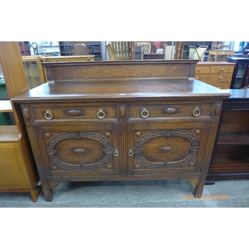 101 - A carved oak sideboard