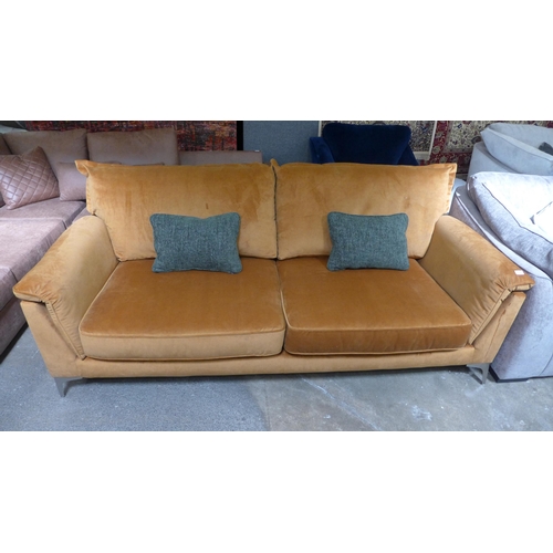 1437 - An ochre velvet four seater sofa with stainless steel legs