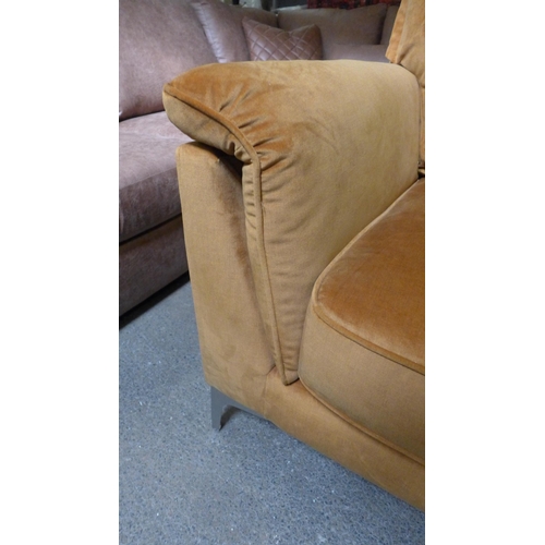 1437 - An ochre velvet four seater sofa with stainless steel legs