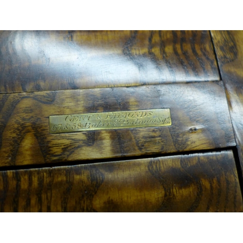 674 - An early 19th Century burr elm book slide, marked Betjemann's on the hinge, retailer's brass plaque ... 