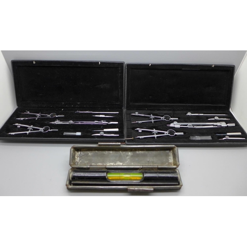 701 - Two technical drawing sets and a spirit level