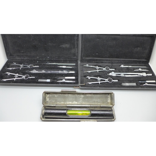 701 - Two technical drawing sets and a spirit level