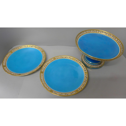 709 - A Minton comport and a pair of plates decorated in blue and gilt border