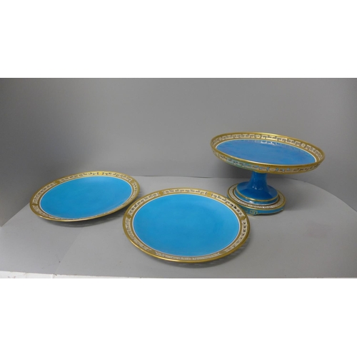 709 - A Minton comport and a pair of plates decorated in blue and gilt border