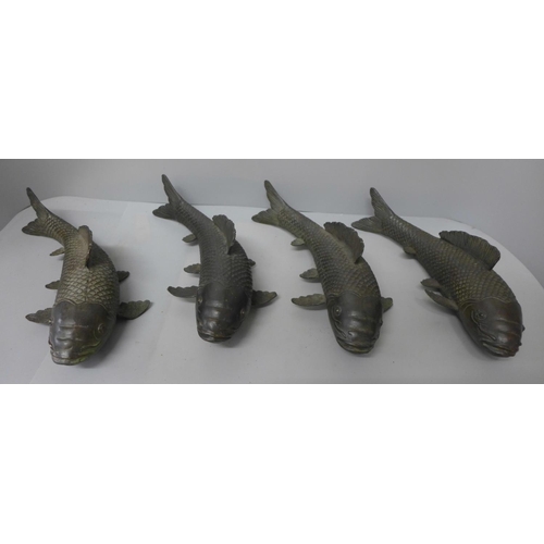 710 - Four bronze models of fish