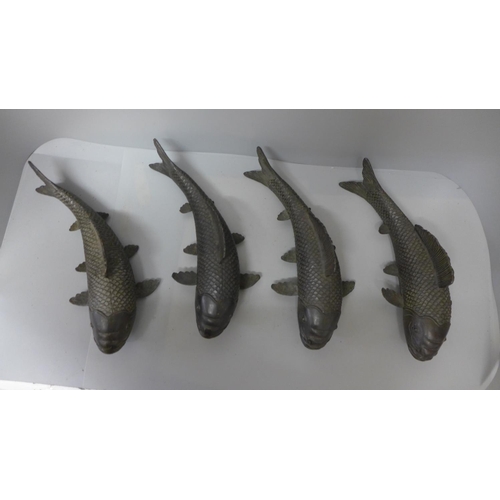 710 - Four bronze models of fish