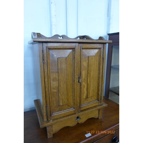 116 - A Victorian Gothic Revival carved oak table top cabinet