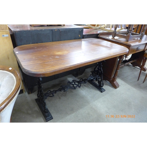 130 - A mahogany and cast iron based pub table