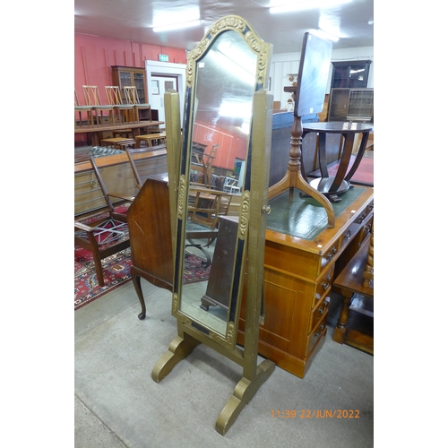 135 - An ebonised and gilt cheval mirror