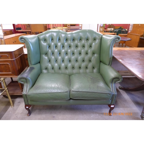 147 - A green leather Chesterfield settee