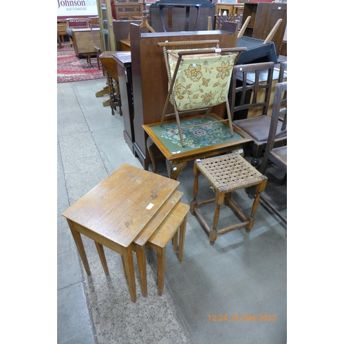 190 - An oak nest of tables, an oak stool, a folding sewing box and an oak embroidery topped coffee table