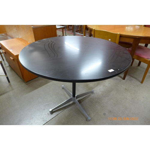 90 - An Eames style circular black and steel based kitchen table