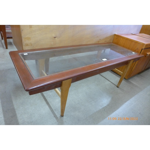 92 - A teak and glass topped coffee table