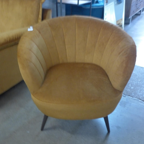 1438 - An ochre velvet shell tub chair