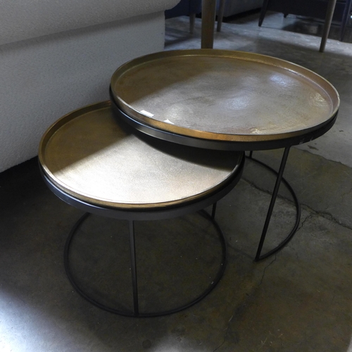 1512 - A circular nest of two black and gold effect tables with removable tray tops