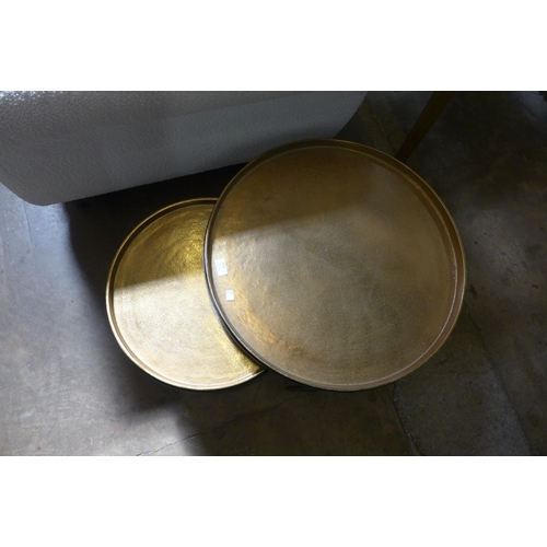 1512 - A circular nest of two black and gold effect tables with removable tray tops