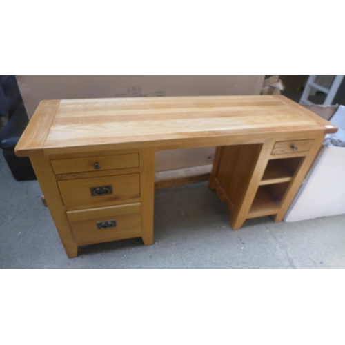 1716 - An oak four drawer desk