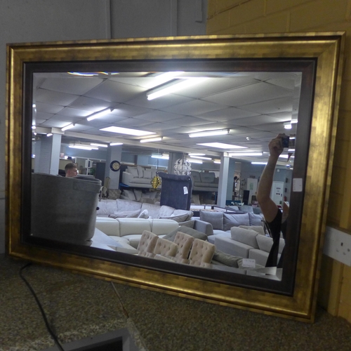 1574a - A large gold framed wall mirror