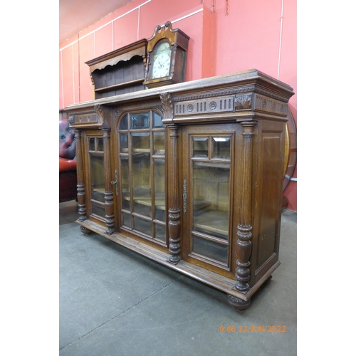 28 - A 19th Century French carved oak three door bookcase