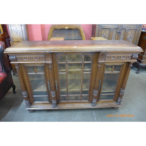 28 - A 19th Century French carved oak three door bookcase