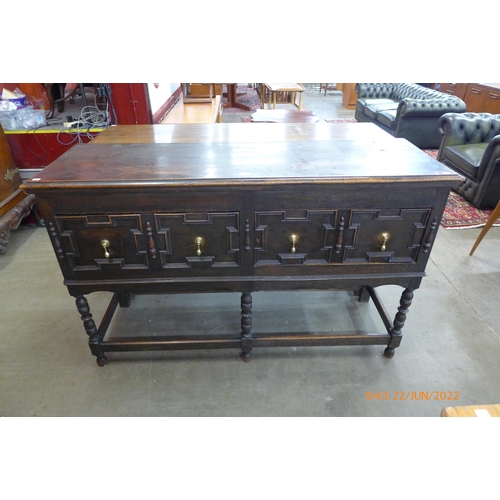 32 - An early 20th Century Jacobean Revival oak geometric moulded dresser