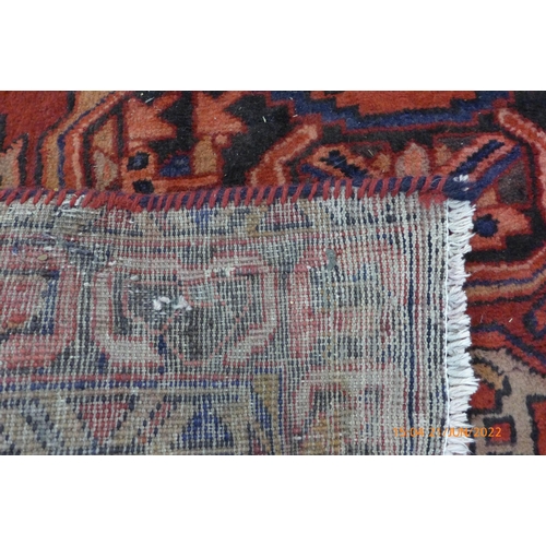 42 - A Persian red ground Herris runner rug, 427 x 115cms