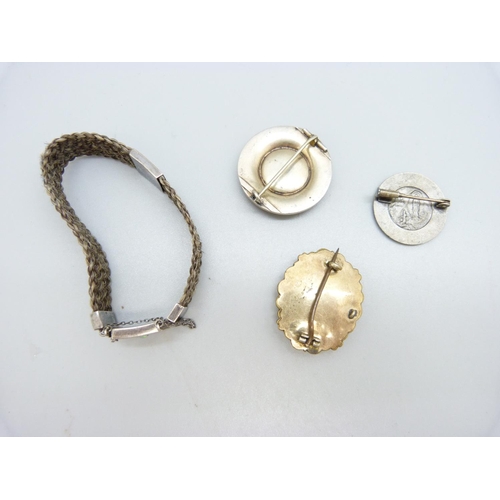 1001 - A hair mourning bracelet set with an opal, two mourning brooches and one other brooch