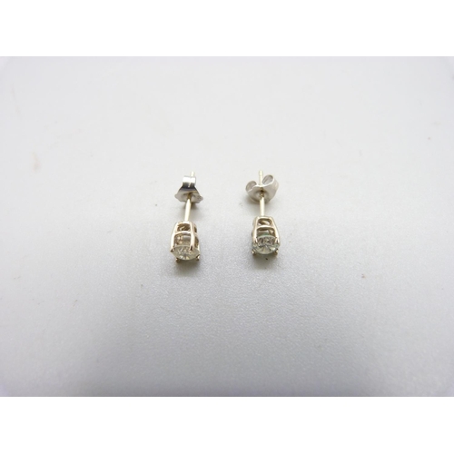 1008 - A pair of 18ct gold, diamond stud earrings, 0.60 total carat weight