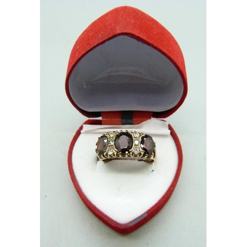 1018 - A silver gilt, white stone and garnet ring, Q