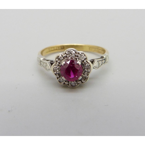 1028 - An 18ct gold, platinum set, ruby and diamond cluster ring, 2.4g, L