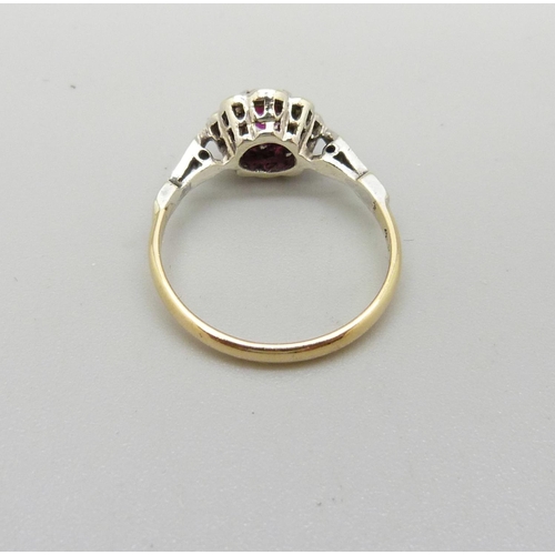 1028 - An 18ct gold, platinum set, ruby and diamond cluster ring, 2.4g, L