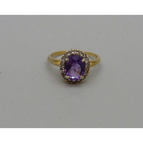 1032 - A silver gilt, amethyst ring with zircon halo, O