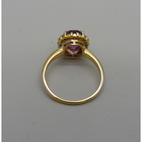 1032 - A silver gilt, amethyst ring with zircon halo, O