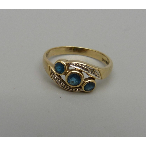 1037 - A 9ct gold, blue stone and small diamond crossover ring, 2.5g, Q