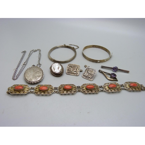 1067 - Silver jewellery including an 800 bracelet set with coral, two bangles, a large locket, etc.