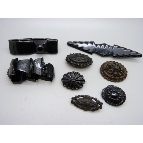 1082 - Two jet bracelets, a jet brooch, a bog oak brooch and four other brooches