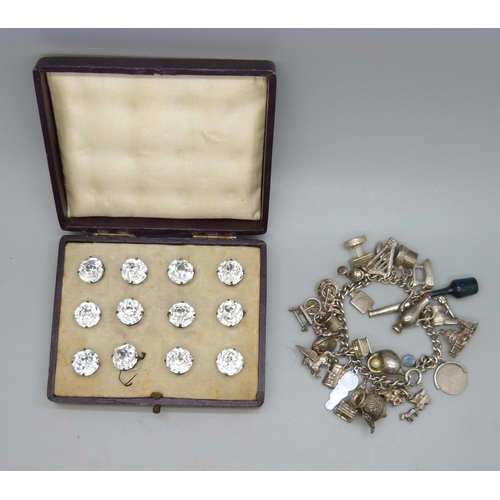 1095 - A charm bracelet and a set of twelve cased buttons