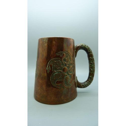 643 - An embossed copper mug