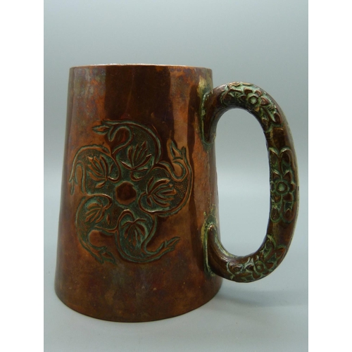 643 - An embossed copper mug