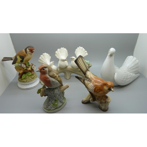 663 - A Lladro figure of a dove, a Spanish figure of three doves on a branch and three other models of bir... 