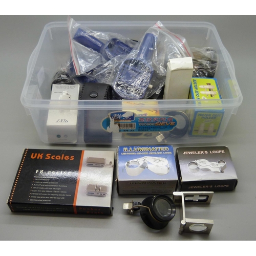 664 - Jeweller's and watchmaker's supplies including loops, a set of scales and watch case holder