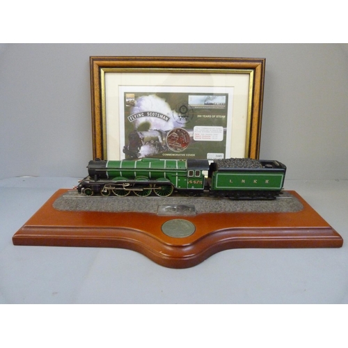 701 - A commemorative Flying Scotsman coin cover and model on wooden plinth