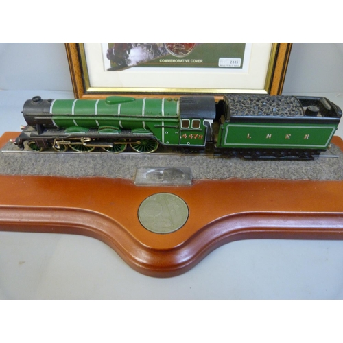 701 - A commemorative Flying Scotsman coin cover and model on wooden plinth